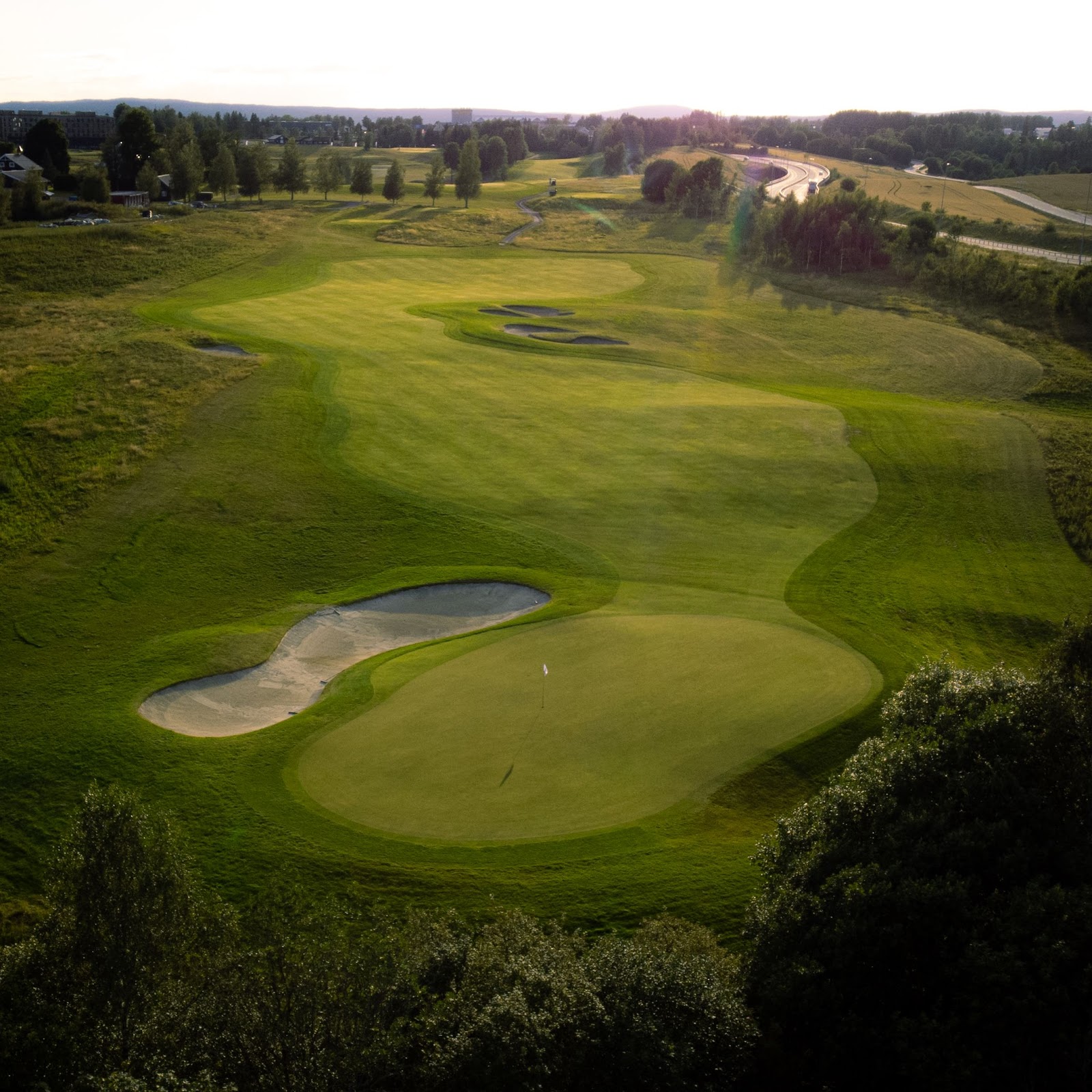 Miklagard Golf near Oslo, Norway, championship fairway framed by forest under summer light