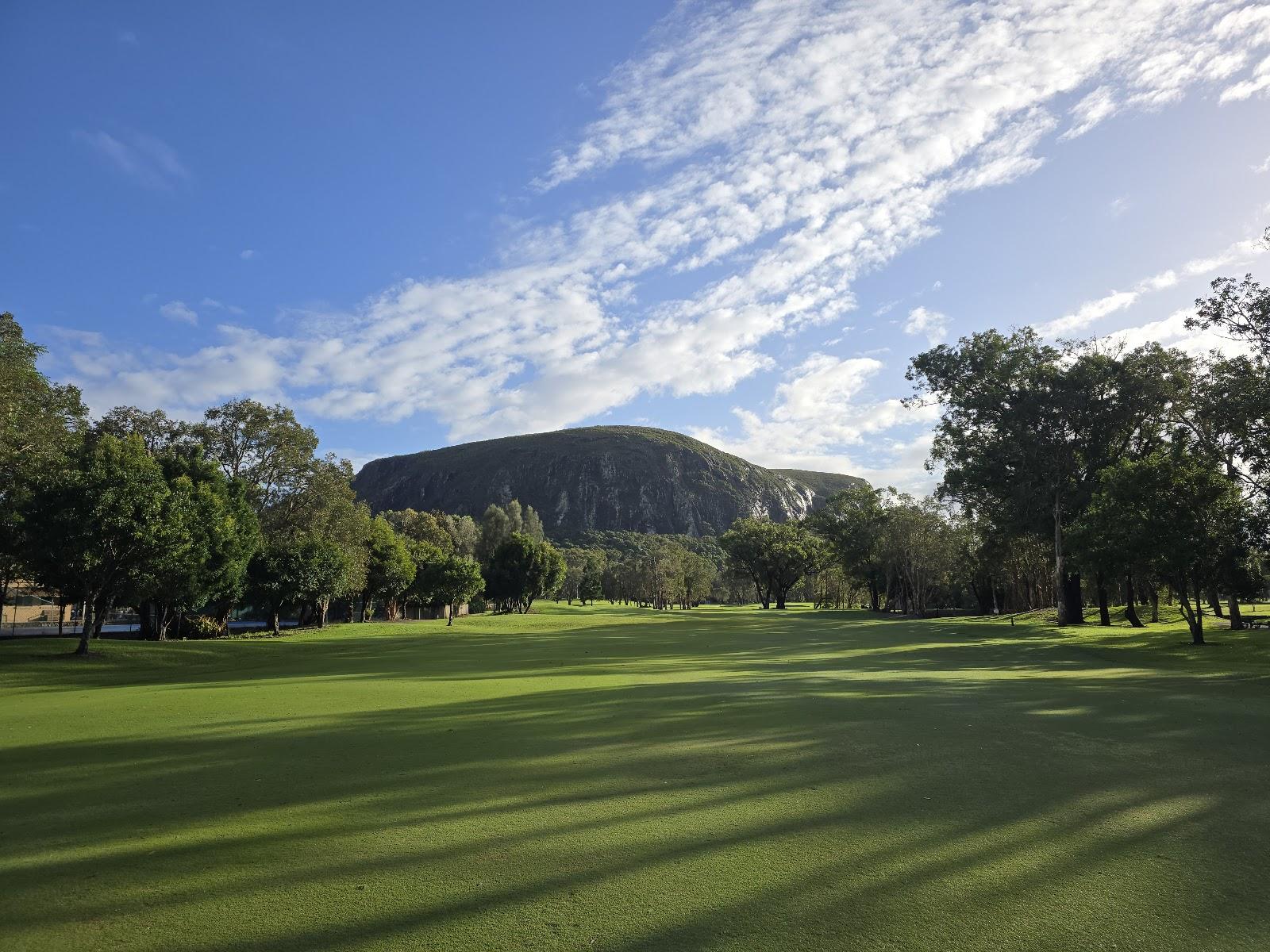 Mount Coolum Golf Club, a flat fairway with water and native bush below the peak of Mount Coolum on the Sunshine Coast in Queensland
