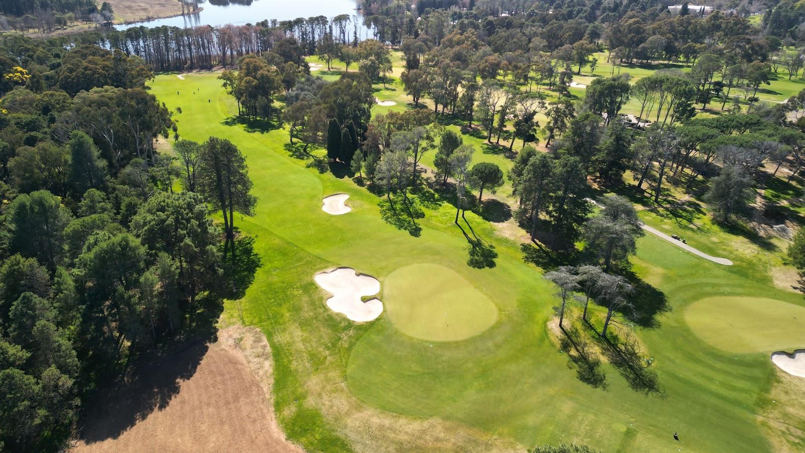Royal Canberra Golf Club at Yarralumla, a manicured parkland fairway among mature trees beside Lake Burley Griffin