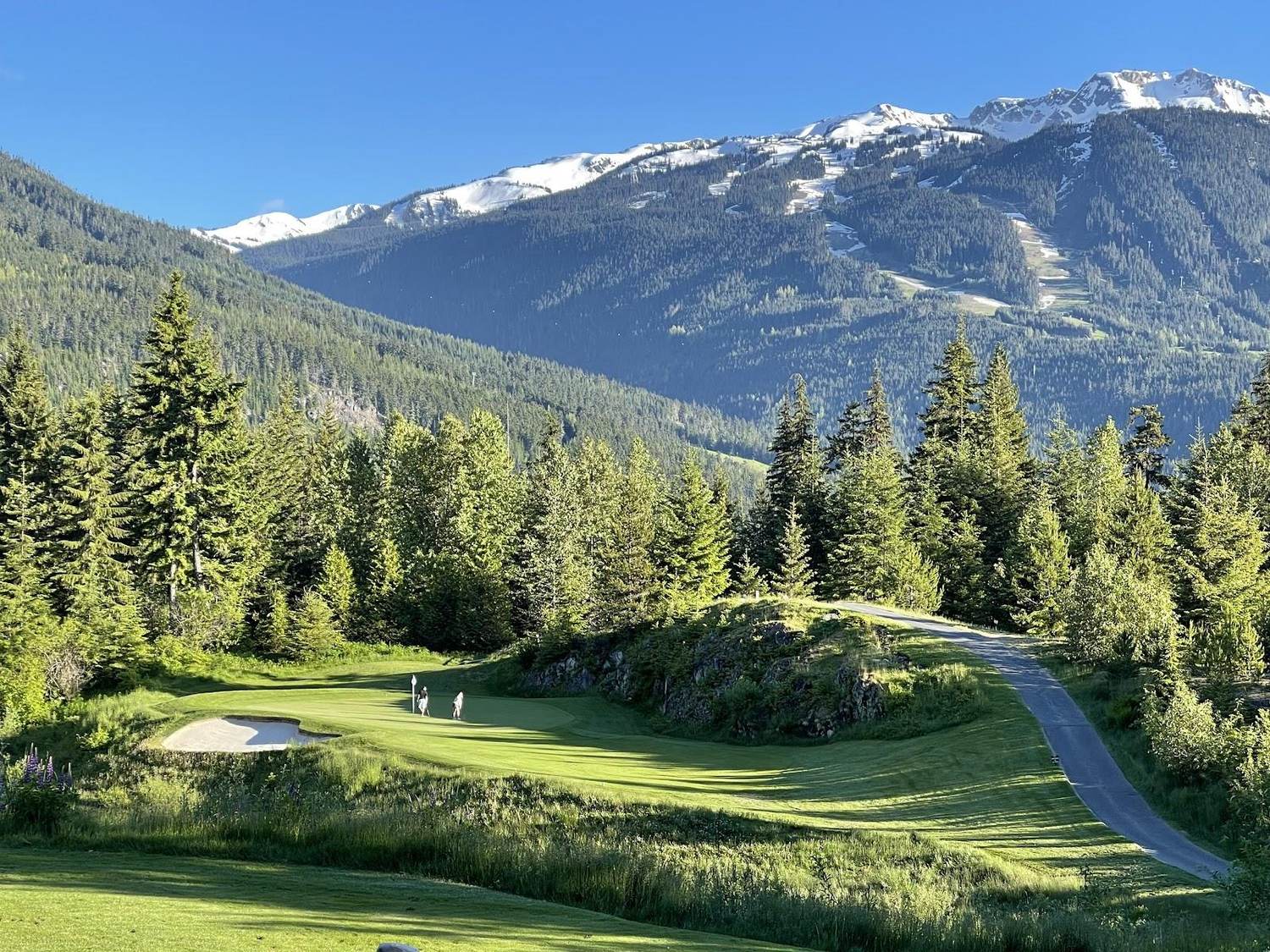 Fairmont Chateau Whistler Golf Club, a mountain fairway rising past rock outcrops on the lower slopes of Blackcomb beneath the chateau, British Columbia, Canada