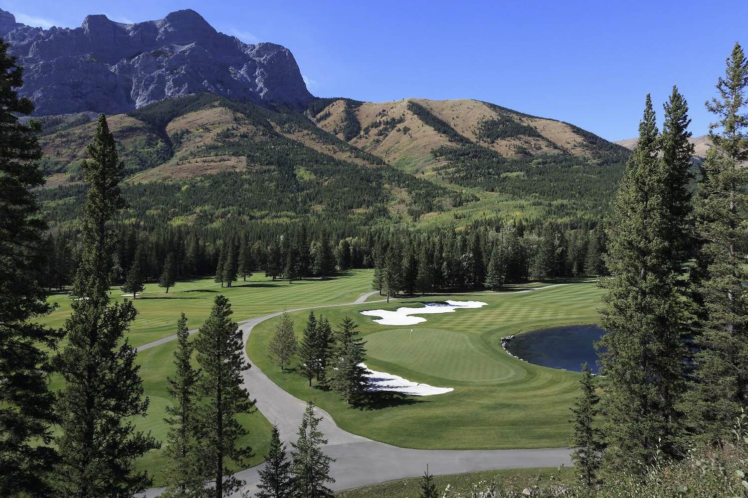 Kananaskis Country Golf Course in Alberta, a valley fairway with glacier fed water and the front ranges of the Canadian Rockies behind, Canada