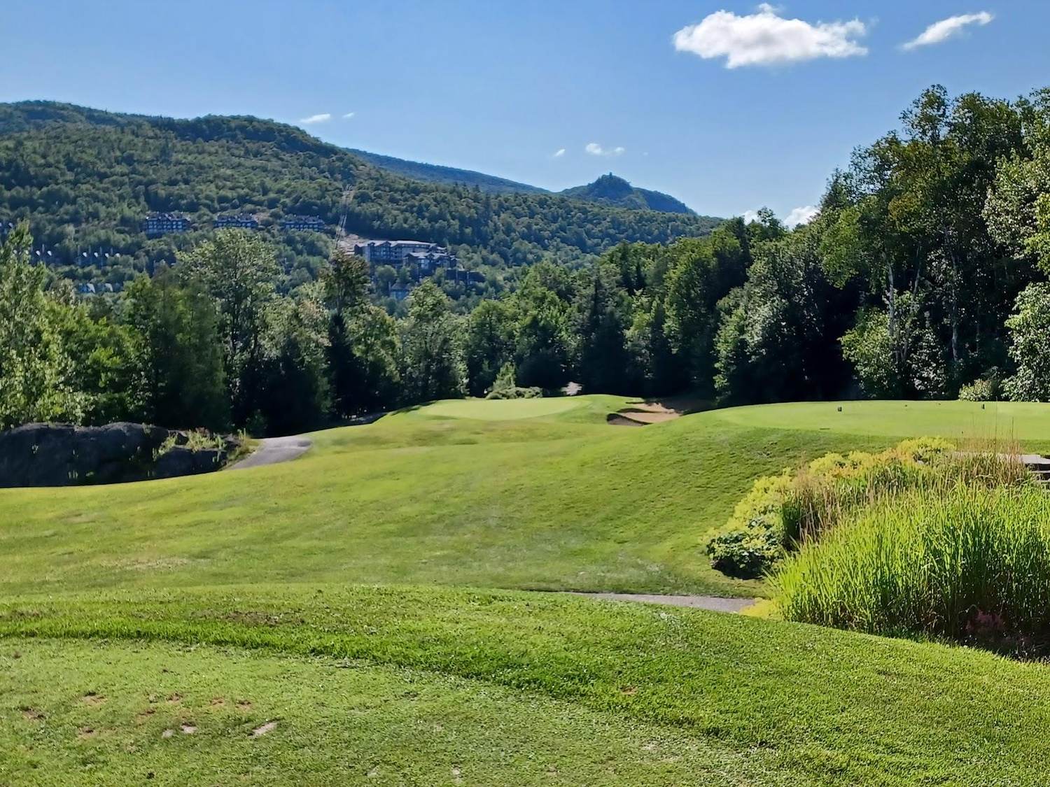 Le Geant golf course at Mont Tremblant, Quebec, fairway dropping down the mountainside with Laurentian peaks beyond