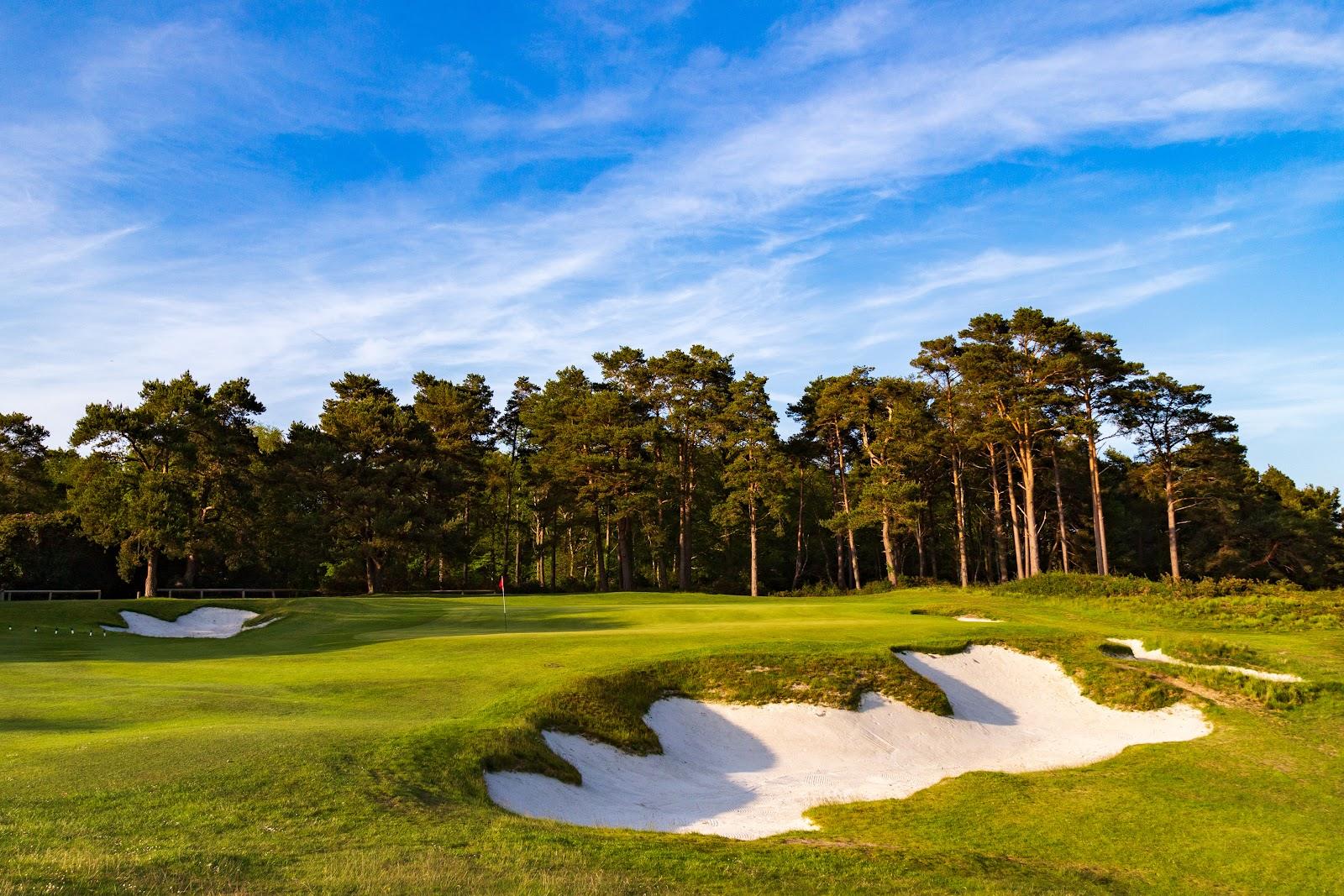 Broadstone Golf Club, elevated heathland fairway over heather and pine in Dorset, England