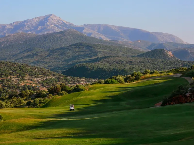 The Crete Golf Club, desert style fairway carved into rocky hillside with mountains and the Aegean Sea beyond, near Hersonissos, Crete