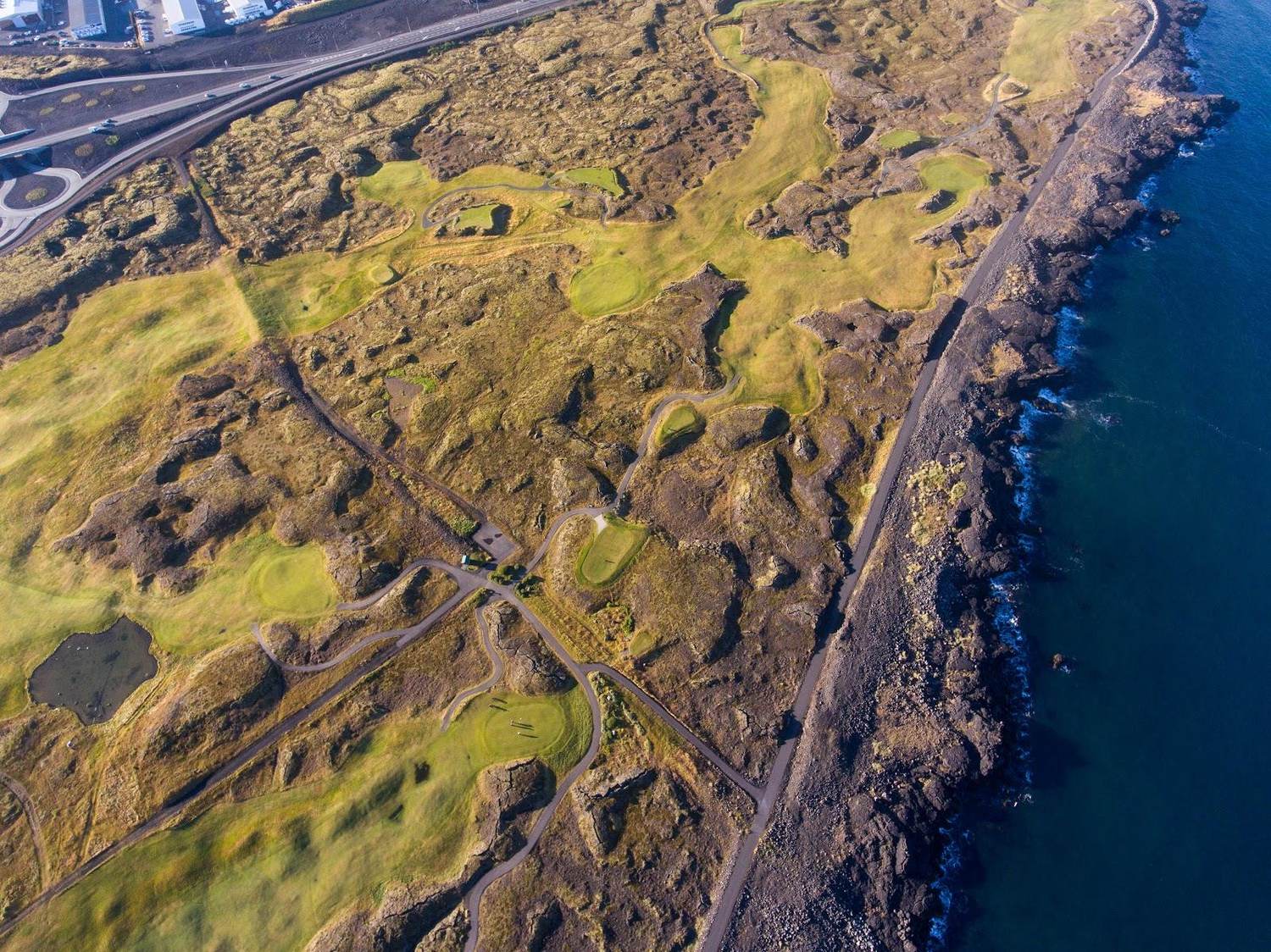 Keilir Golf Club, fairway between lava fields and the sea on the Hvaleyri peninsula, Iceland