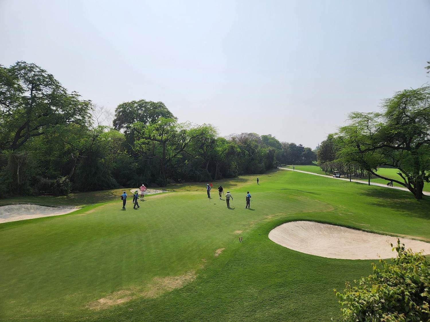 Delhi Golf Club, the Lodhi Course with a Mughal era tomb beside a mature parkland fairway in New Delhi, India