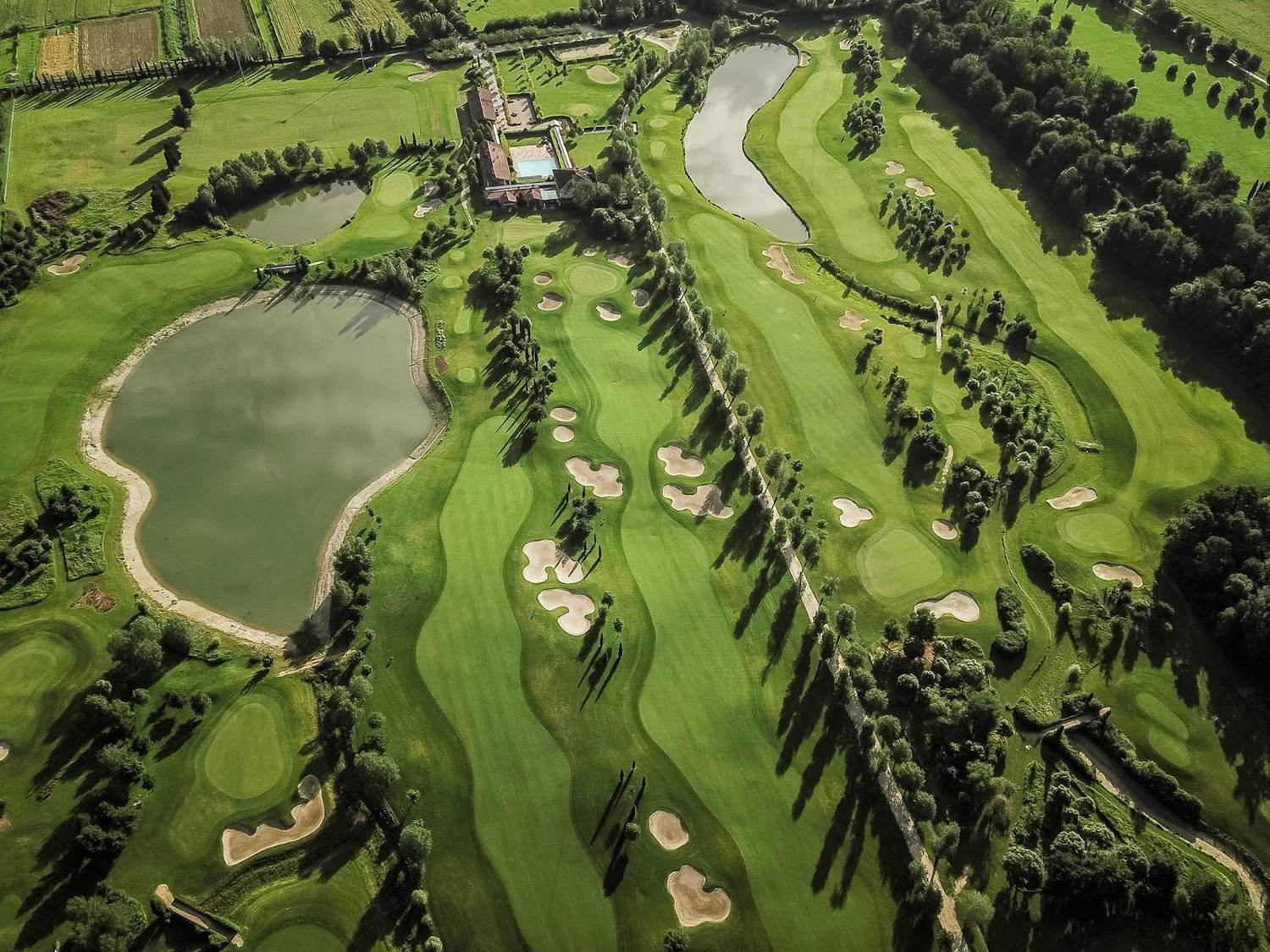 Le Pavoniere Golf and Country Club, parkland fairway and water on the Tuscan plain near Prato
