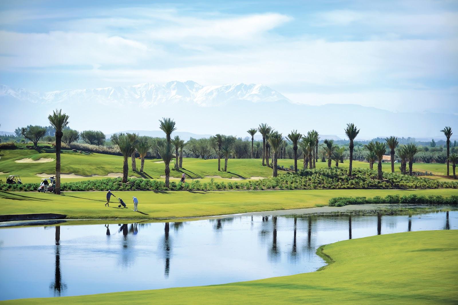 Fairmont Royal Palm Marrakech golf course, fairway and palms with the Atlas Mountains beyond, Morocco