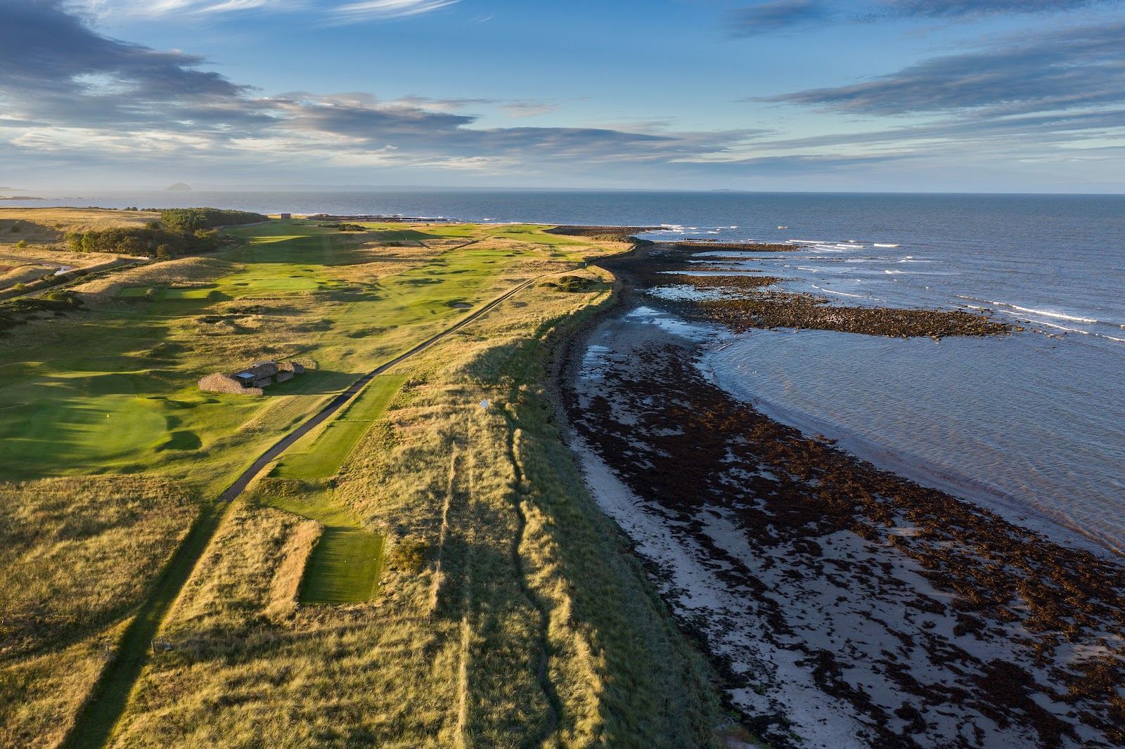 Dunbar Golf Club links running along the rocky Firth of Forth shoreline in East Lothian