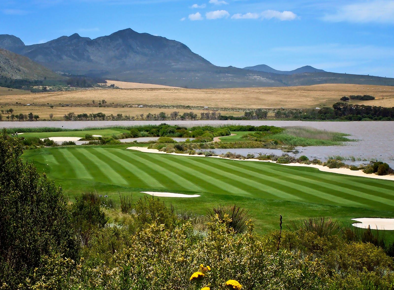 Arabella Golf Club, fairways edged with fynbos running down to the Bot River Lagoon beneath the Kogelberg mountains near Kleinmond, South Africa
