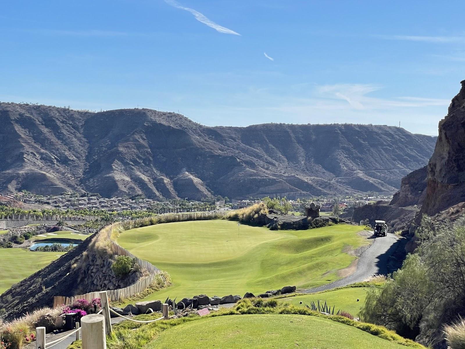 Anfi Tauro Golf, green fairway against red volcanic rock in the Tauro Valley, Mogan, Gran Canaria, Spain