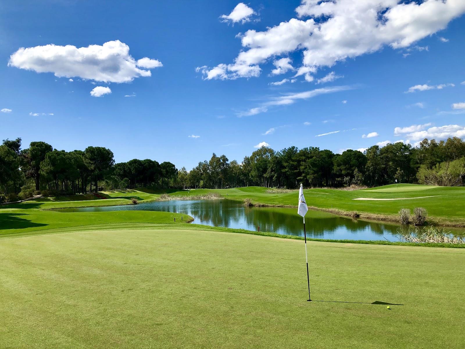 Antalya Golf Club Pasha Course, tree lined fairway and lake in Belek, Turkey
