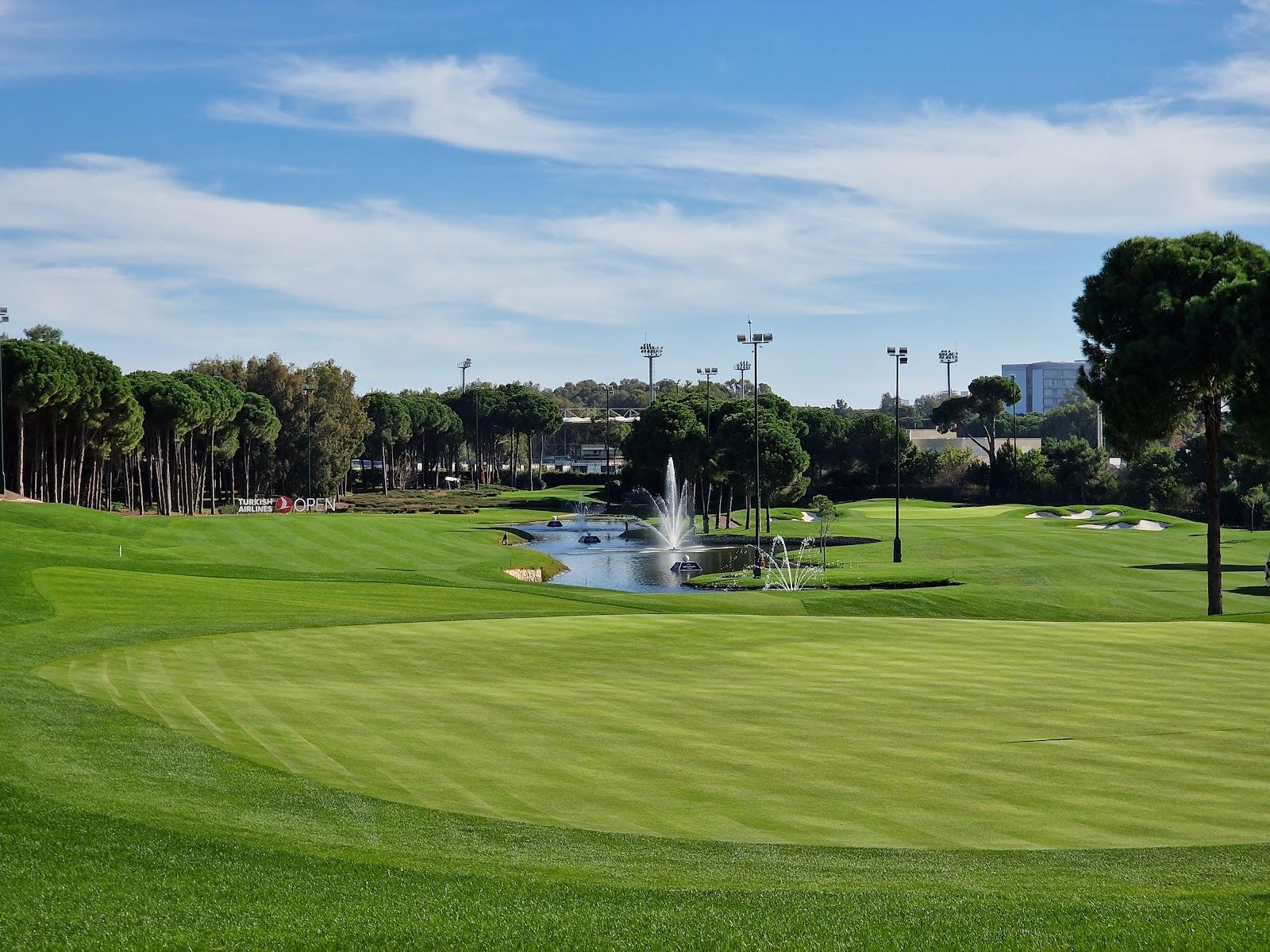Carya Golf Club, Belek, a heathland fairway lined with pines under floodlights on the Turkish coast