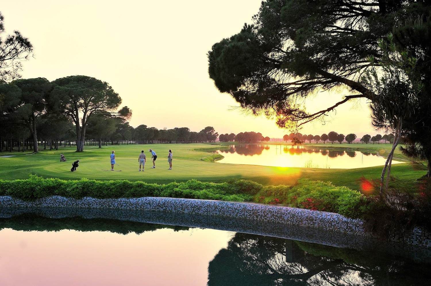 Gloria New Course, a pine lined fairway with water at Belek on the Turkish Riviera