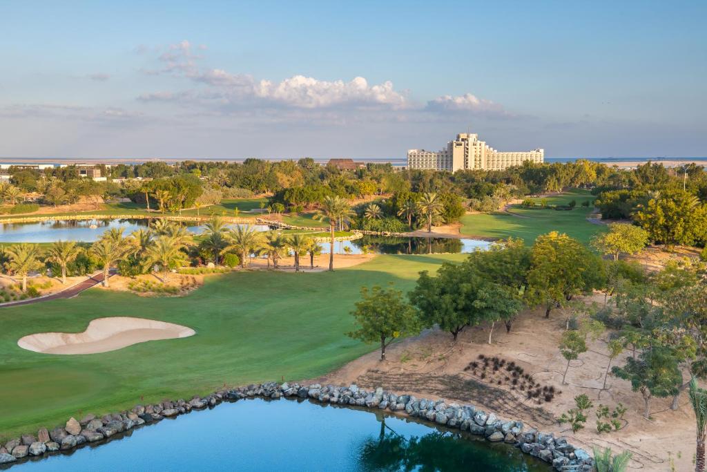Jebel Ali Golf Resort, palm lined fairway beside a saltwater lake on the Dubai coast, United Arab Emirates