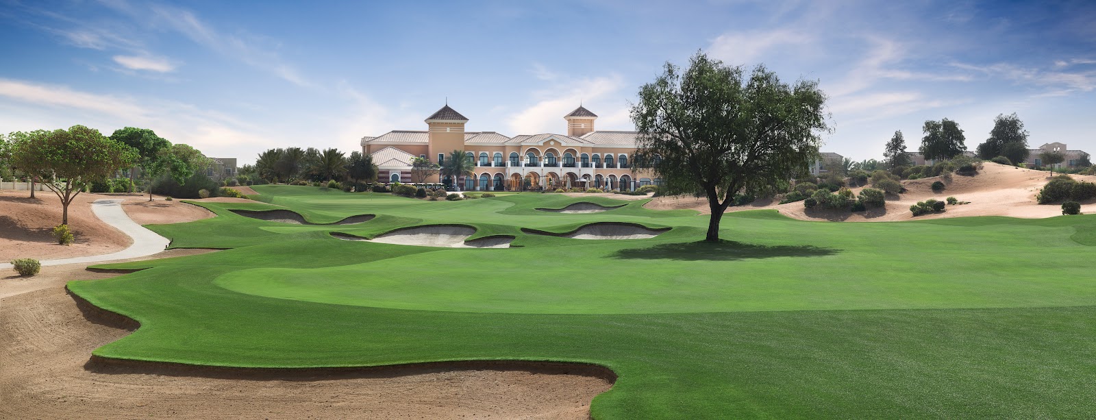 The Els Club Dubai, desert links fairway with sculpted bunkering at Dubai Sports City, United Arab Emirates