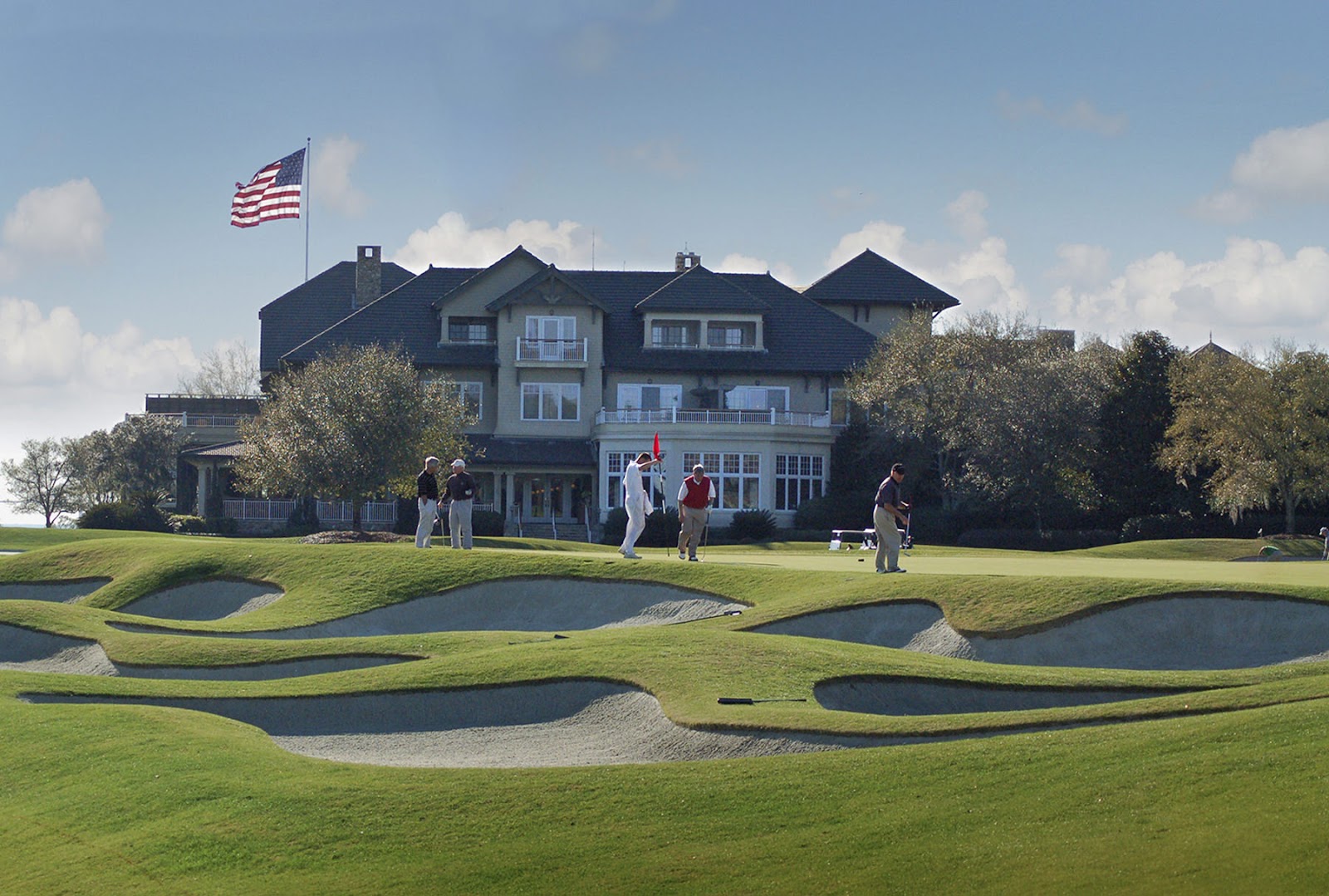 The Plantation Course at Sea Island, Georgia, a squared off plateau green amid Golden Age bunkering