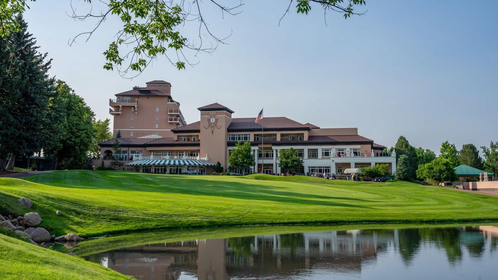 The Broadmoor West Course, fairways climbing the Cheyenne Mountain foothills above Colorado Springs