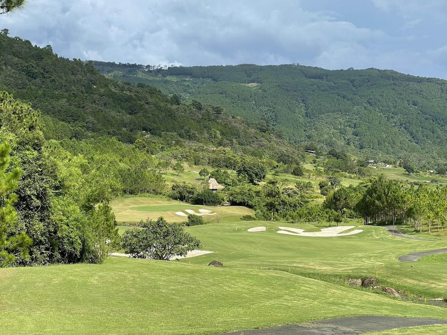 The Dalat at 1200 Country Club, alpine fairway through pine forest above a spring fed lake, Vietnam