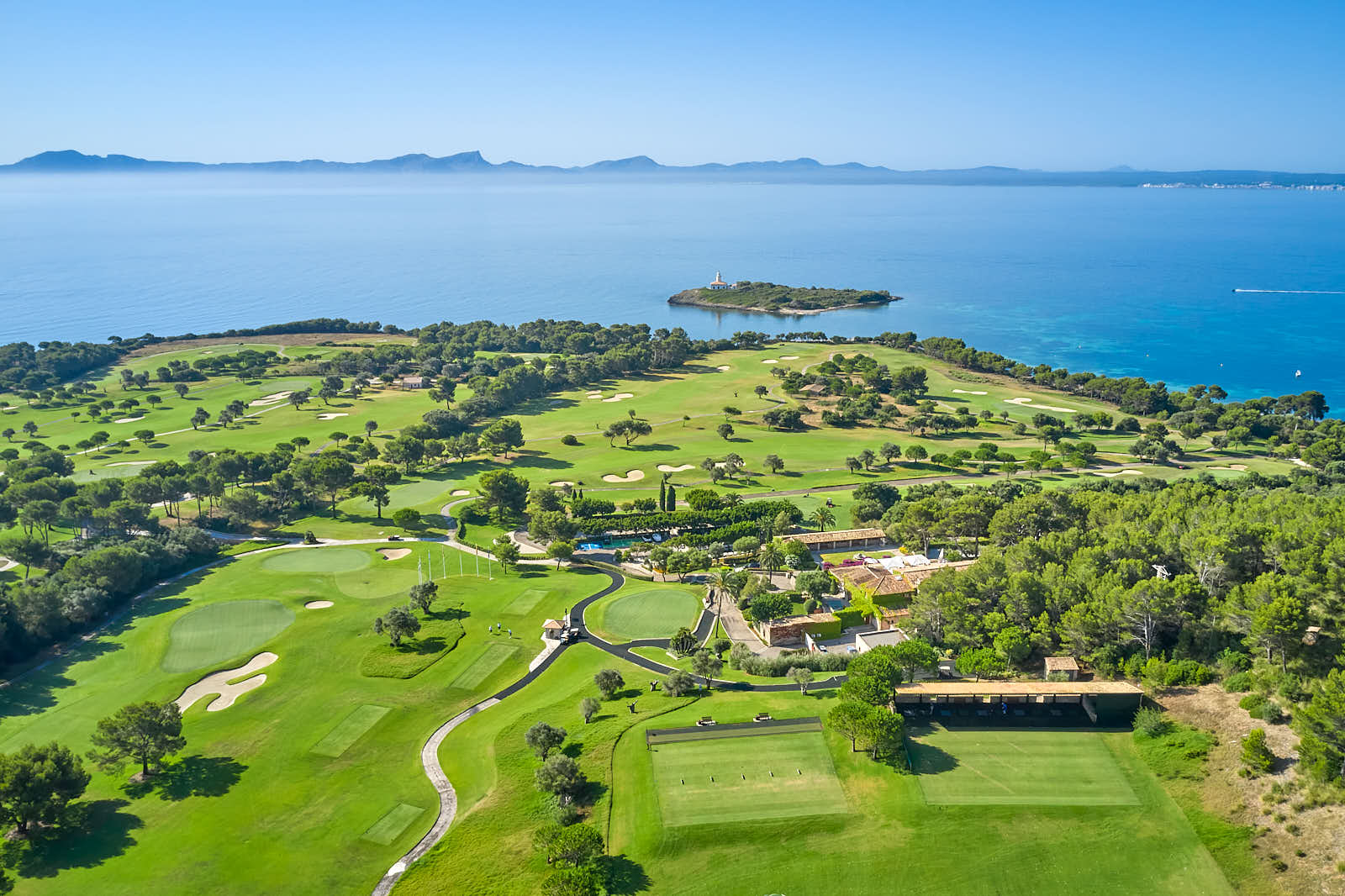 Club de Golf Alcanada and its lighthouse on the bay of Alcudia, Mallorca