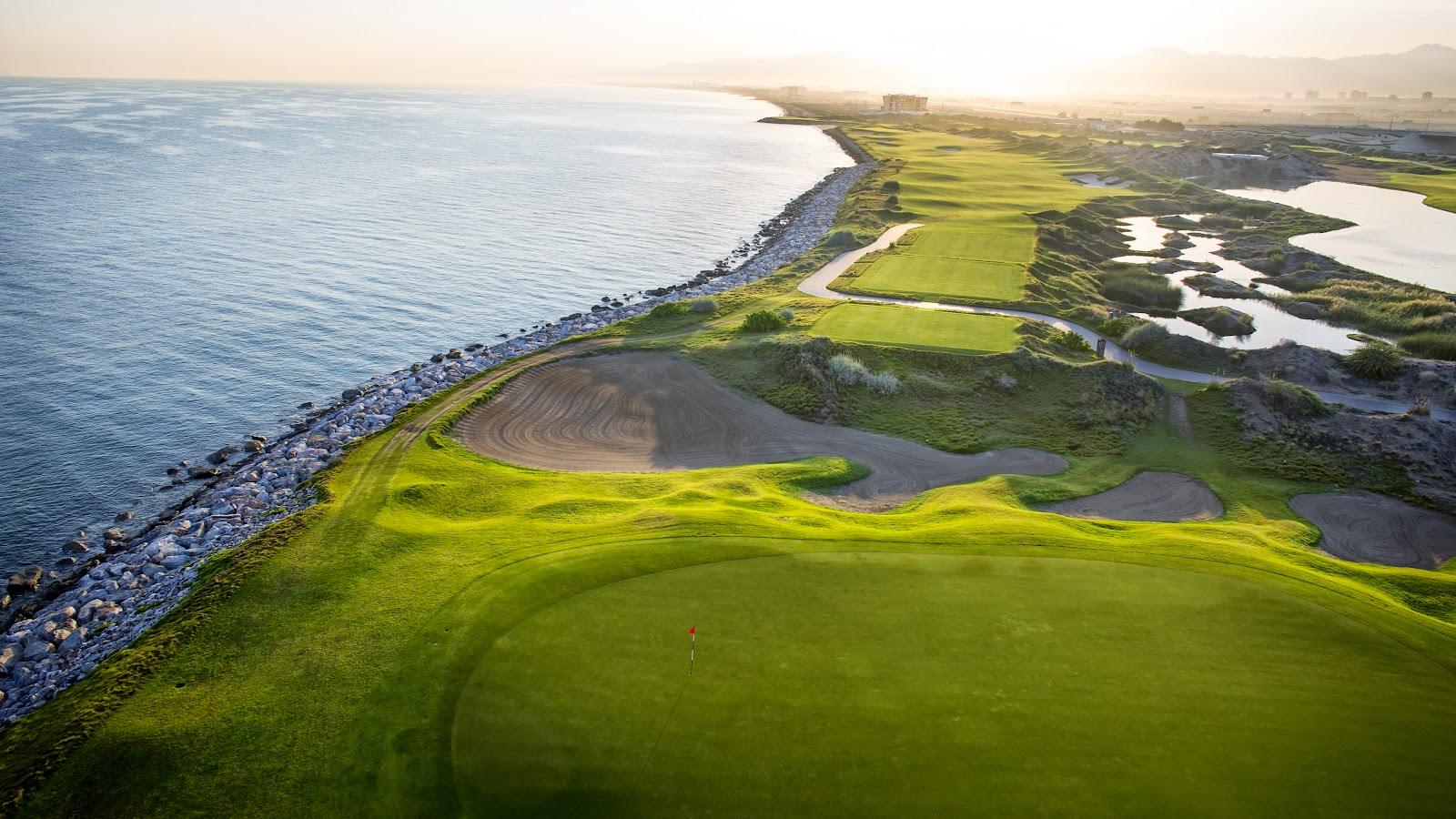 Al Mouj Golf links along the Indian Ocean beneath the Hajar mountains in Muscat, Oman